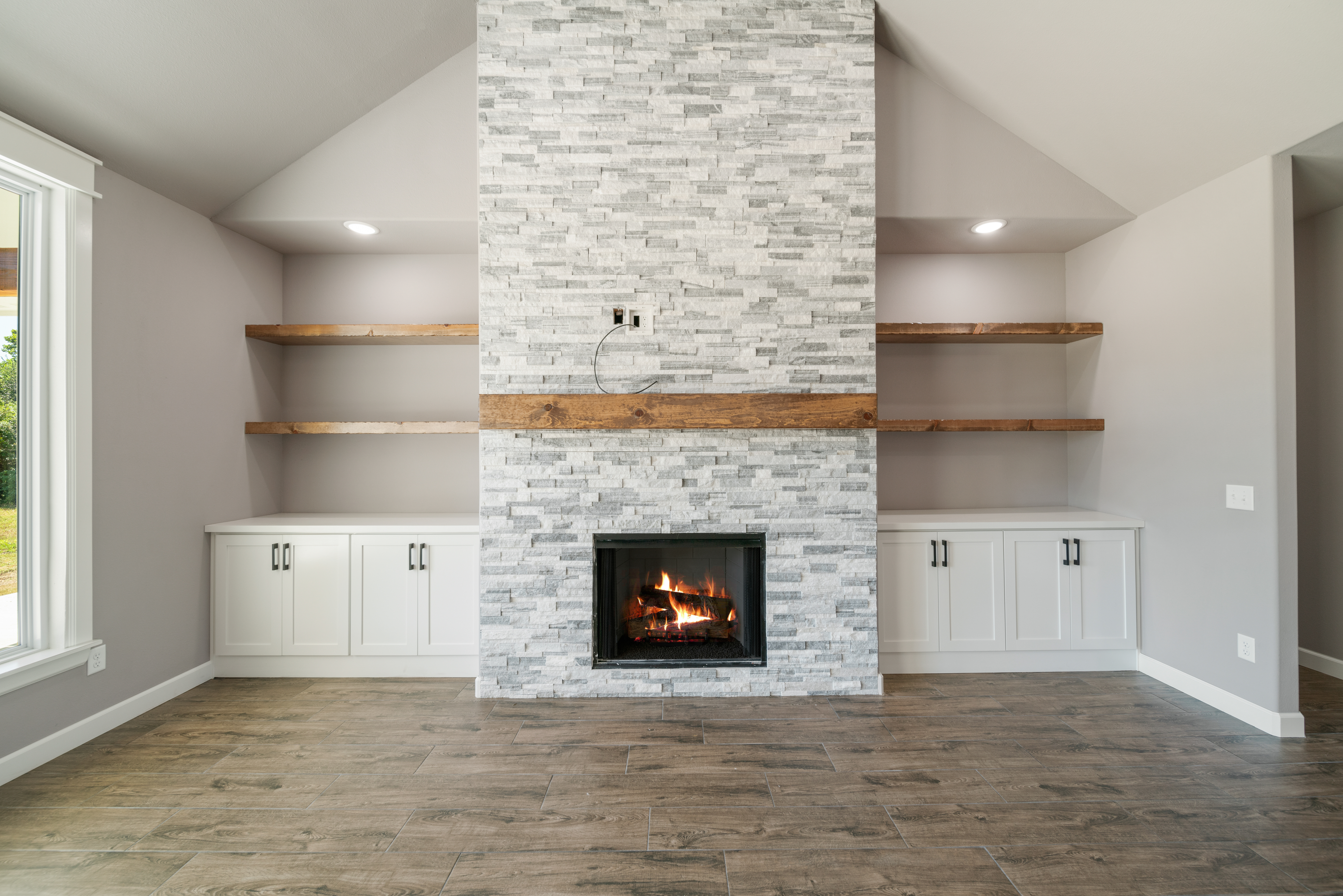 Spacious and comfortable living room with designer touches by Mahogany Homes Tulsa.