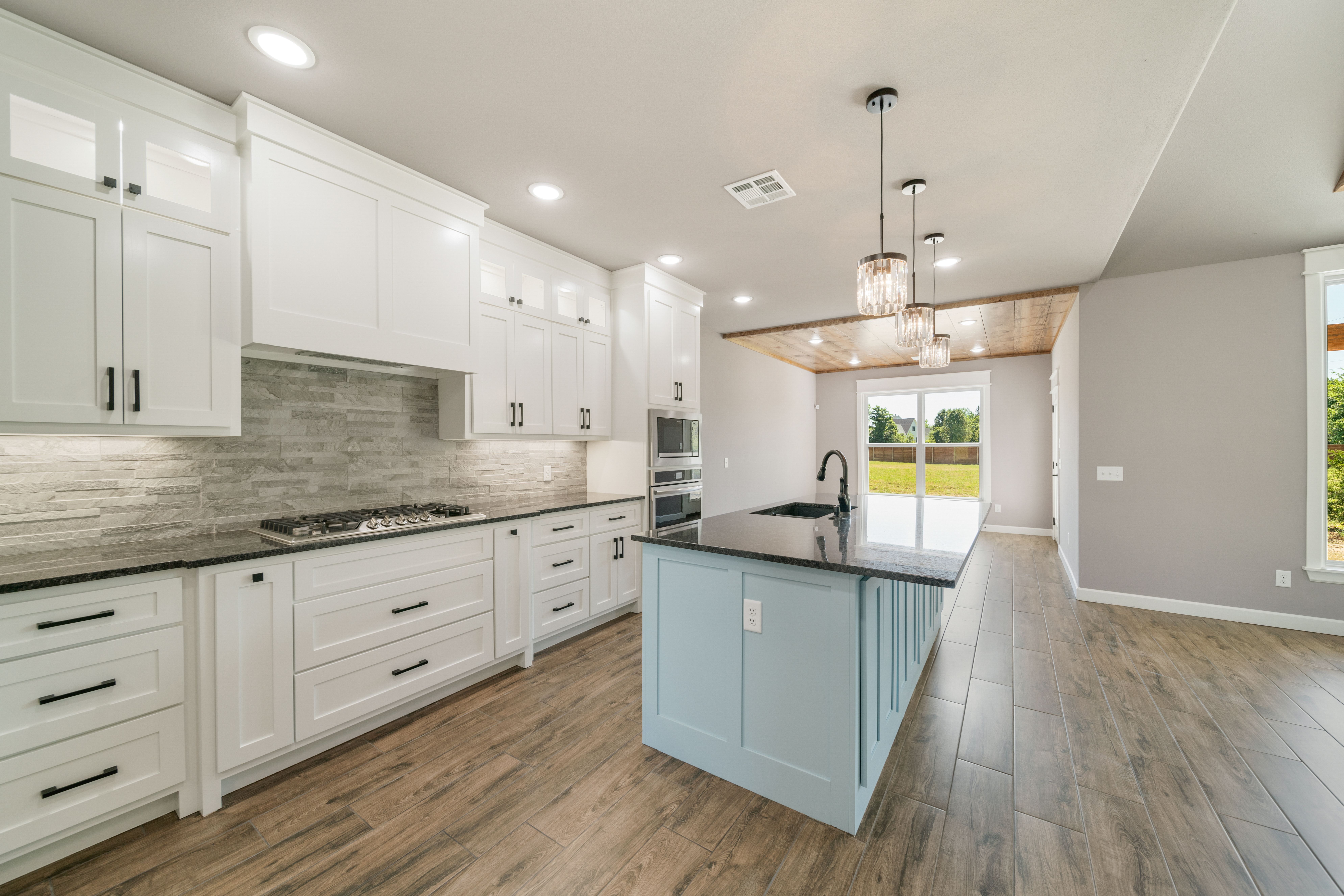 Luxury kitchen featuring granite countertops and custom cabinetry by Mahogany Homes Tulsa.