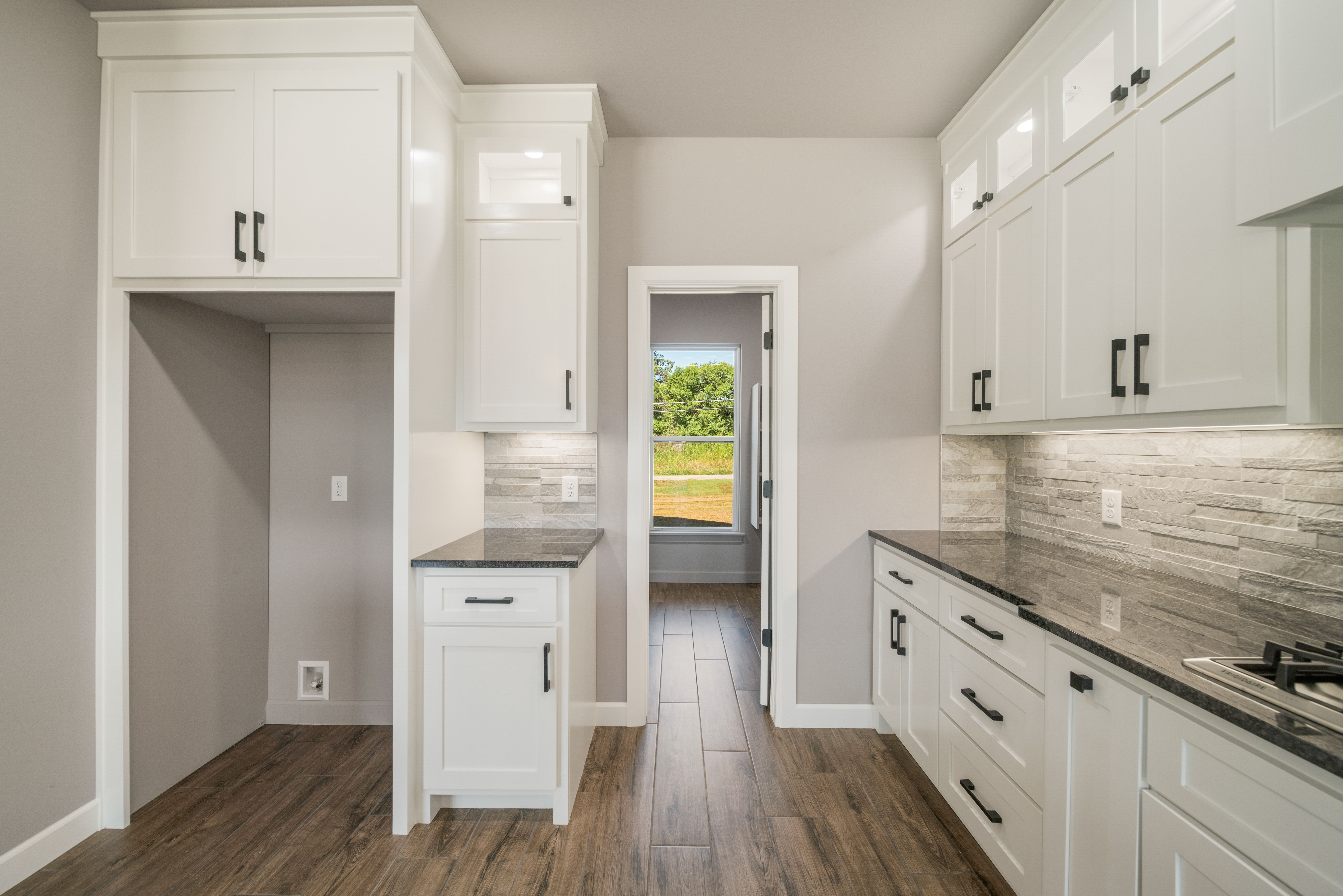 Elegant kitchen with an open layout and custom finishes by Mahogany Homes.