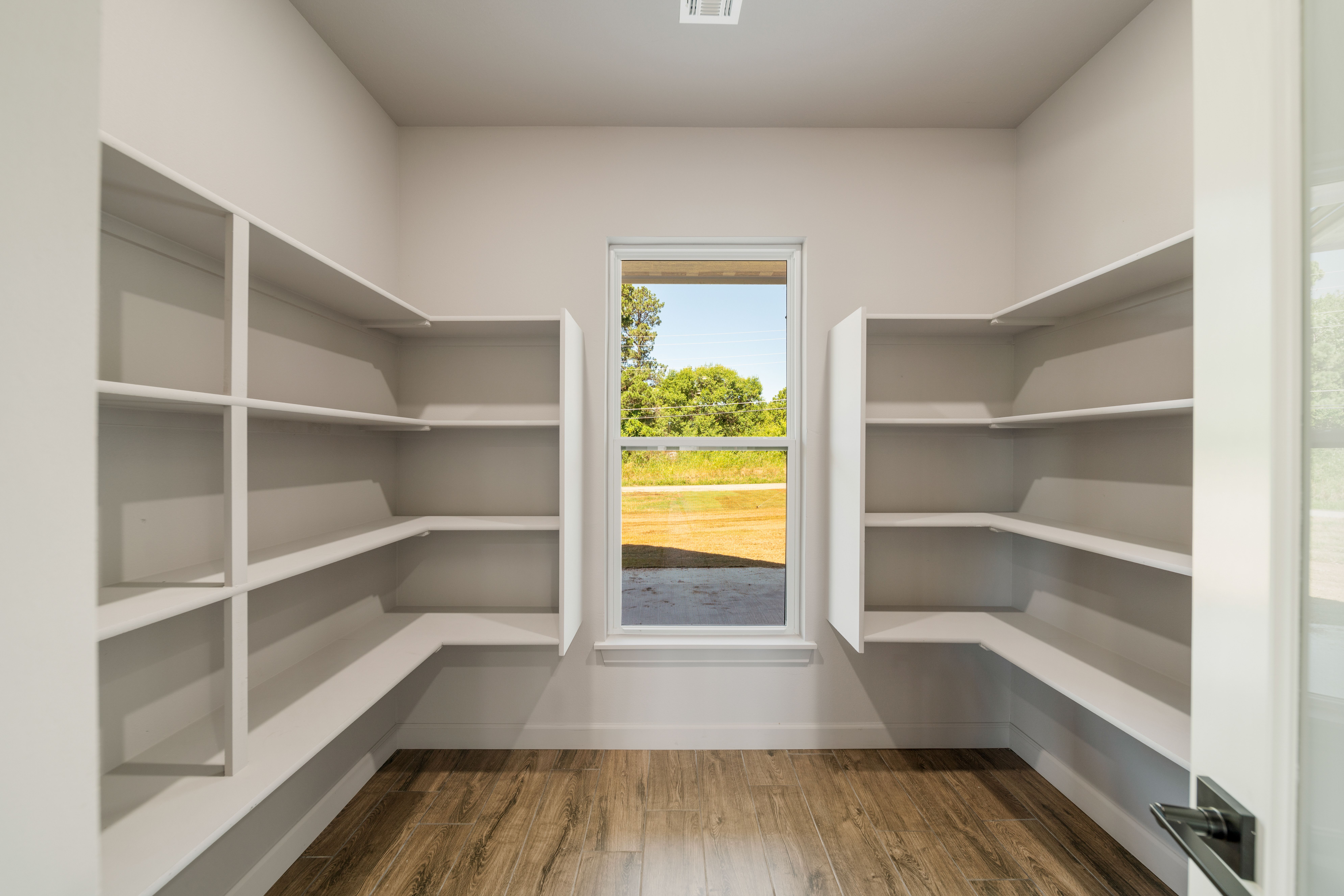 Bright and spacious kitchen with modern appliances and custom cabinetry by Mahogany Homes Tulsa