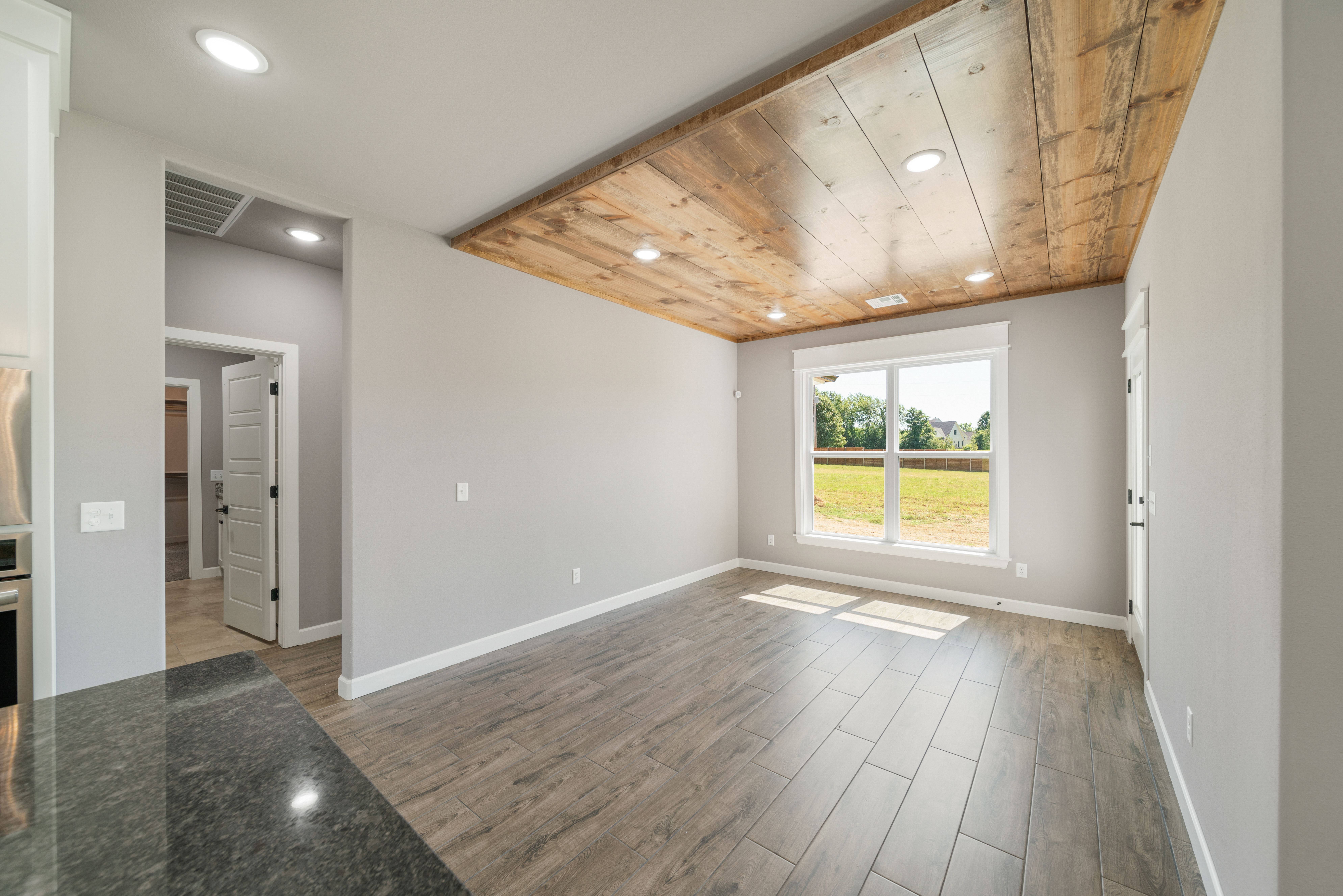 Chic living room featuring expansive windows and unique design elements by Mahogany Homes.