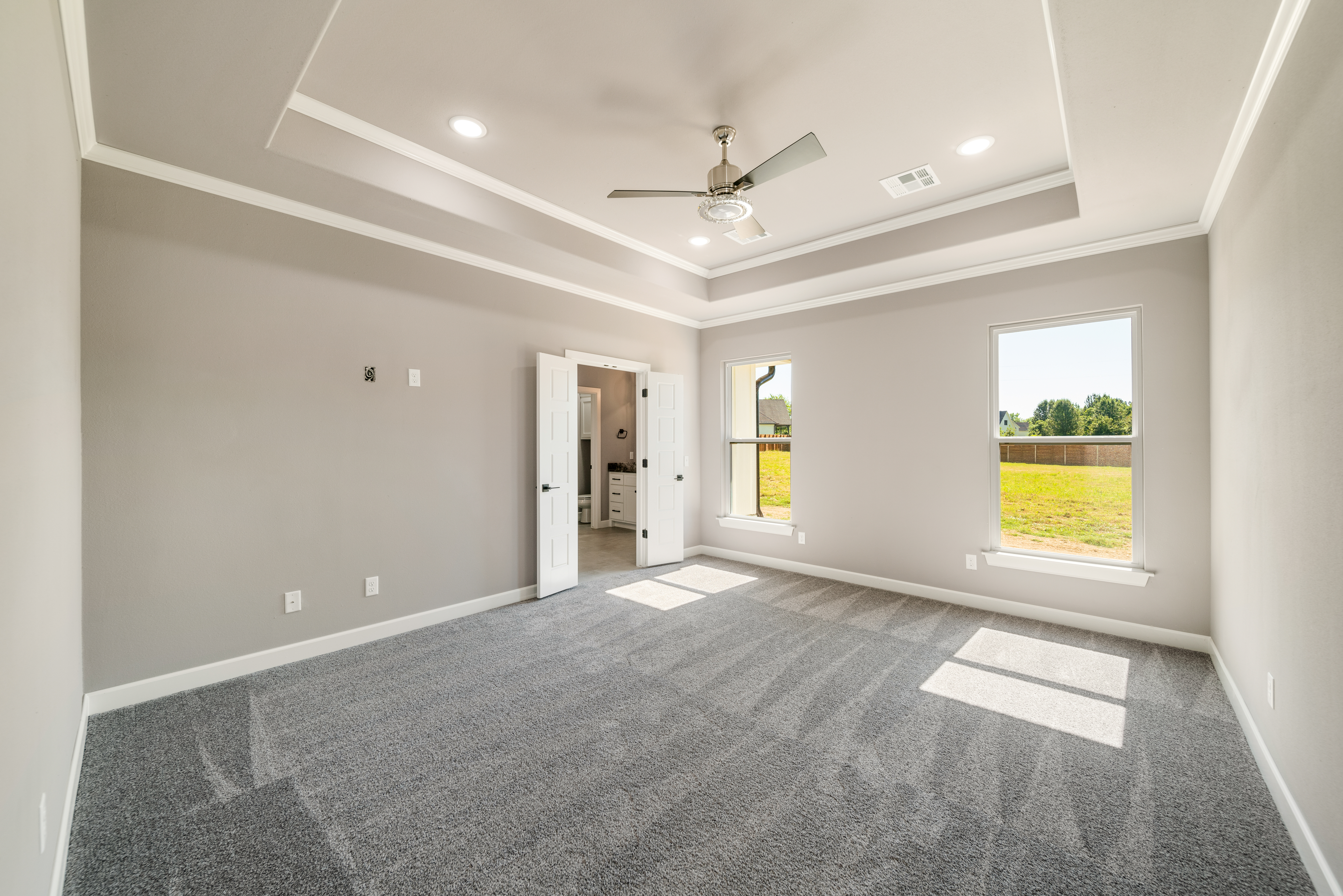 Open-concept floor plan with a spacious kitchen, dining area, and living room by Mahogany Homes