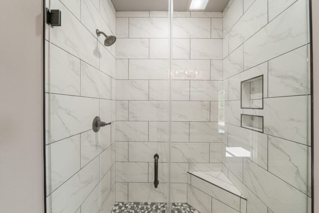Modern bathroom design featuring sleek fixtures and custom storage by Mahogany Homes Tulsa.