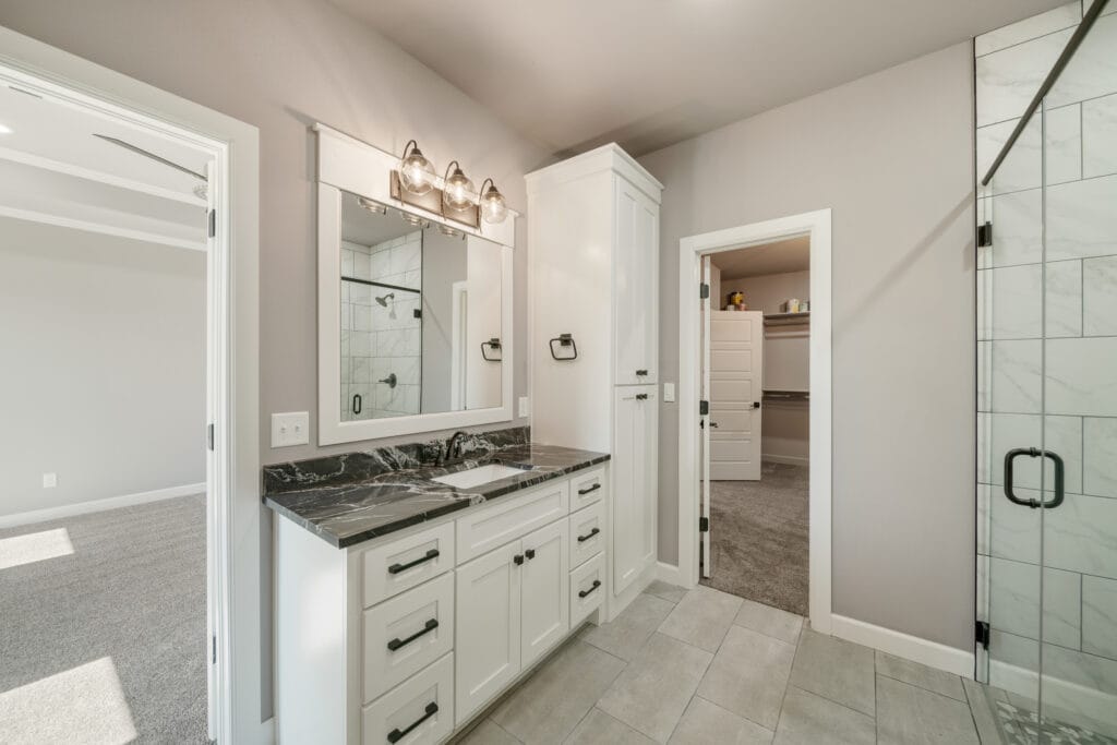 Spa-like bathroom with a freestanding tub and designer details by Mahogany Homes Tulsa.