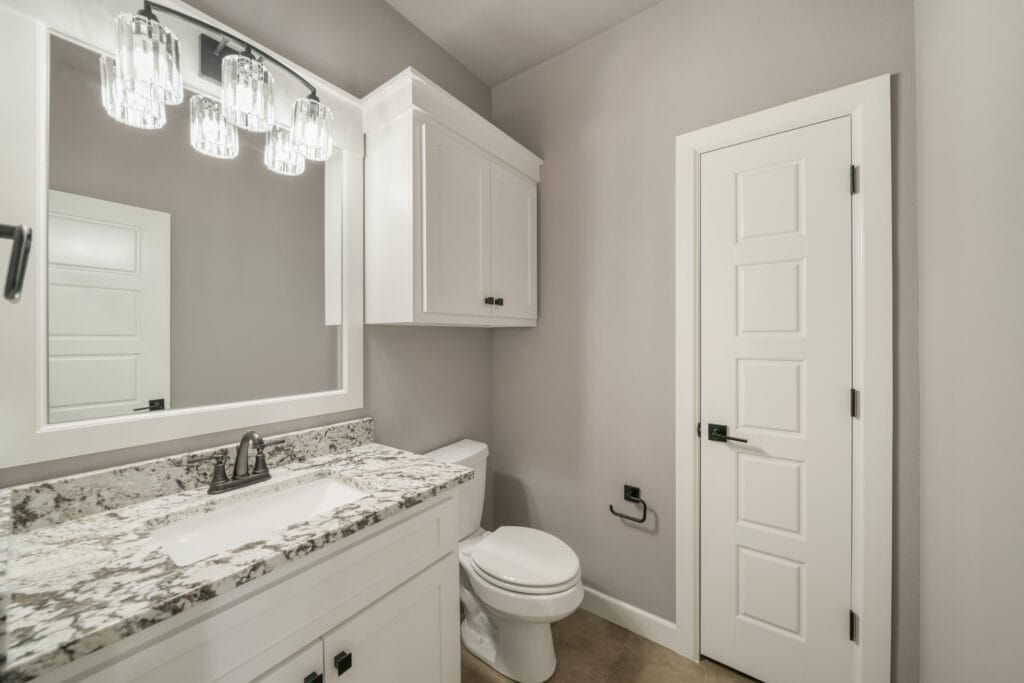 Luxurious bathroom with a freestanding soaking tub and custom tilework by Mahogany Homes Tulsa.