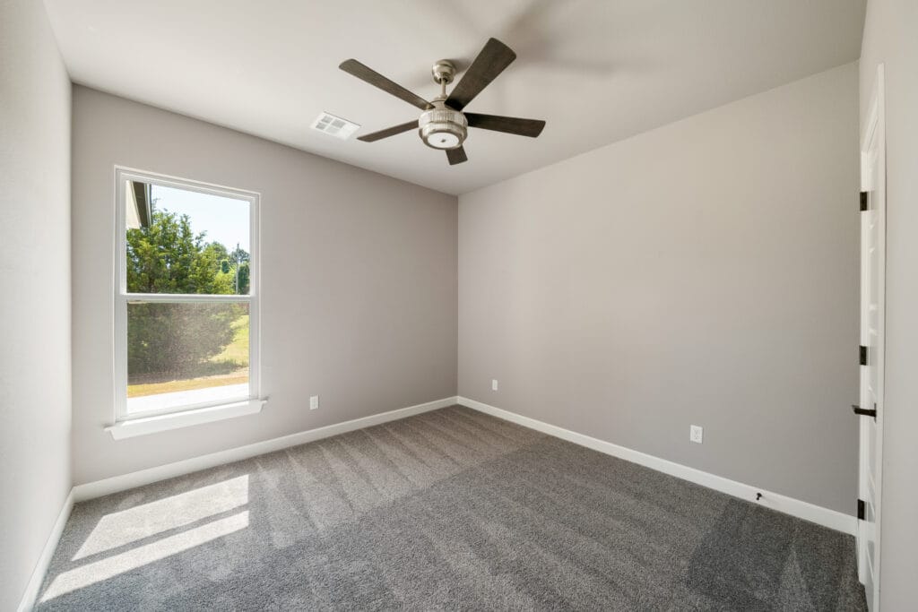Custom-designed floor plan with efficient use of space, including a spacious kitchen and large living room by Mahogany Homes.