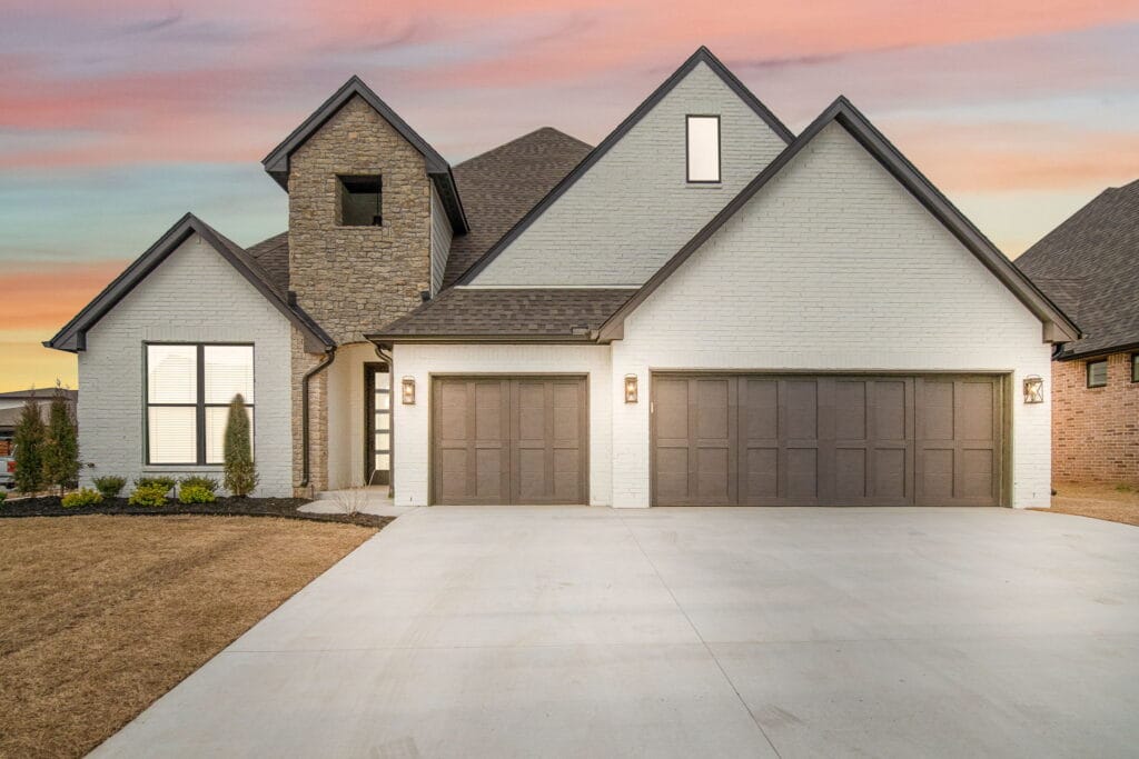 Charming home with a modern facade by Mahogany Homes Tulsa.