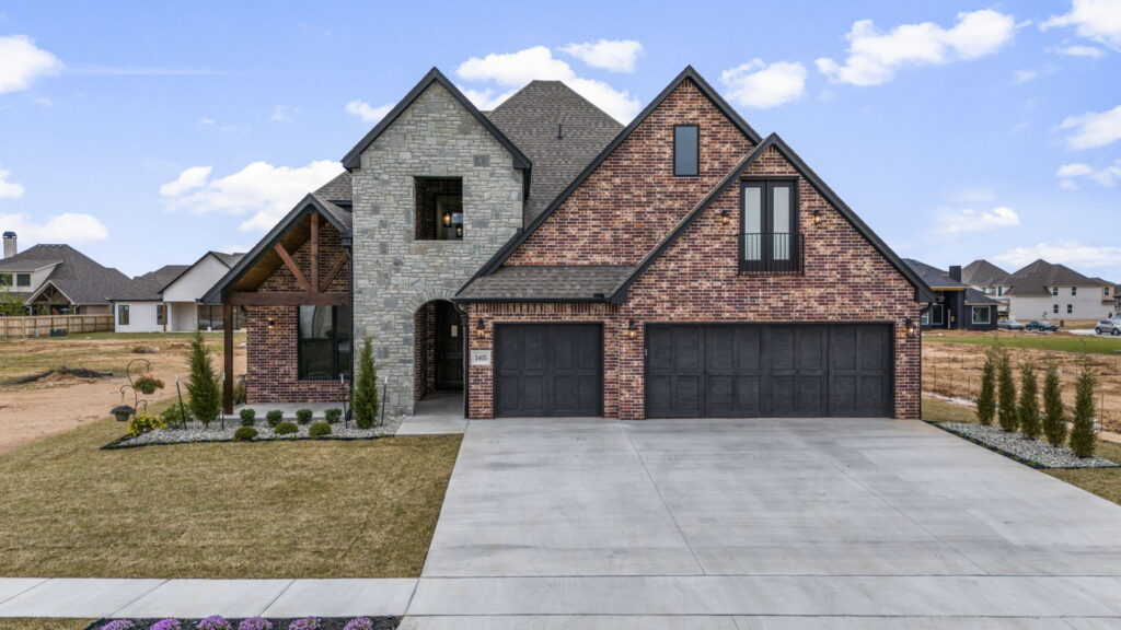 Custom home exterior with expansive landscaping and modern touches by Mahogany Homes Tulsa.