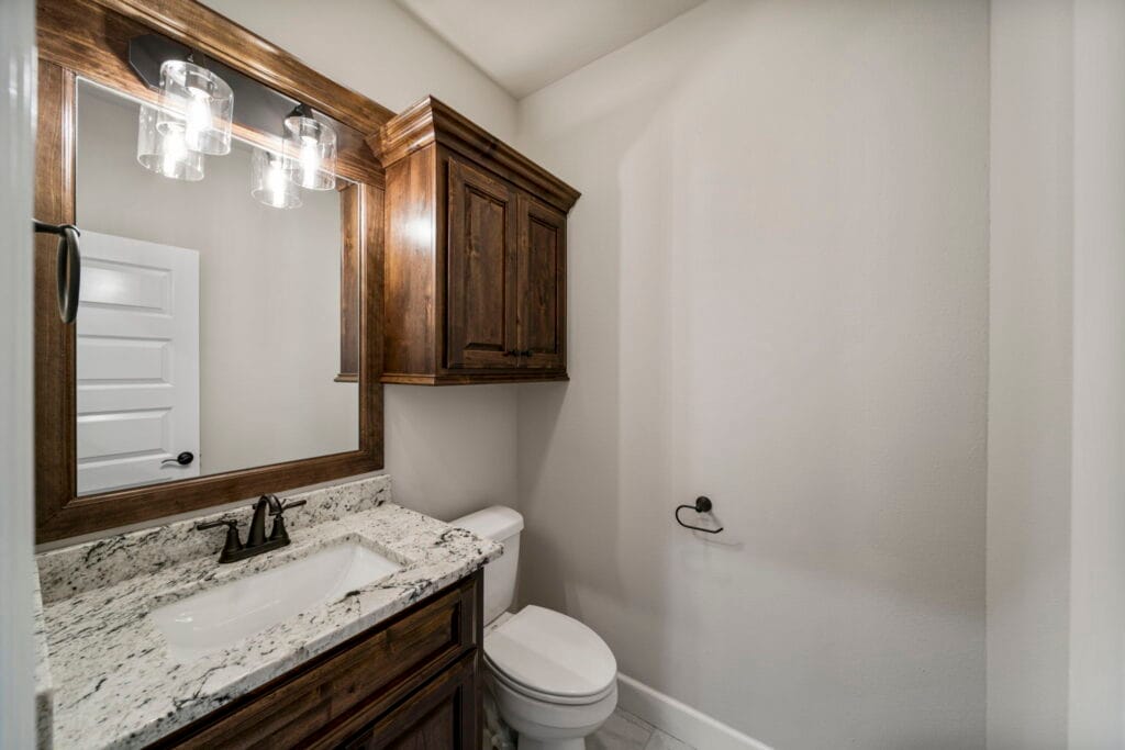 Elegant bathroom with a sleek, modern design and custom tilework by Mahogany Homes Tulsa.