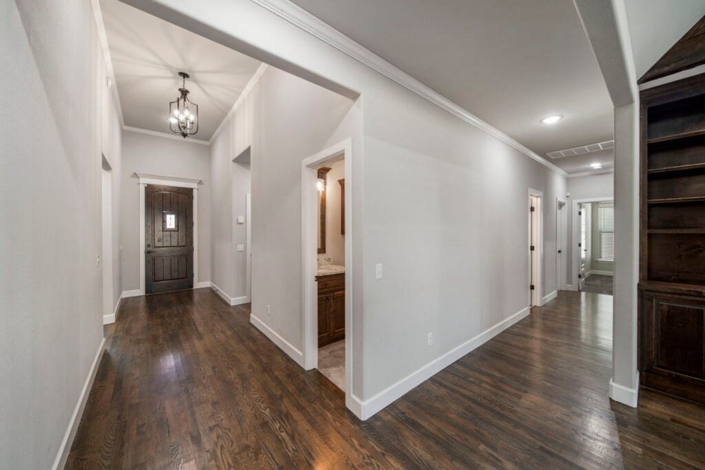 Custom floor plan featuring an open kitchen, large living areas, and designer details by Mahogany Homes