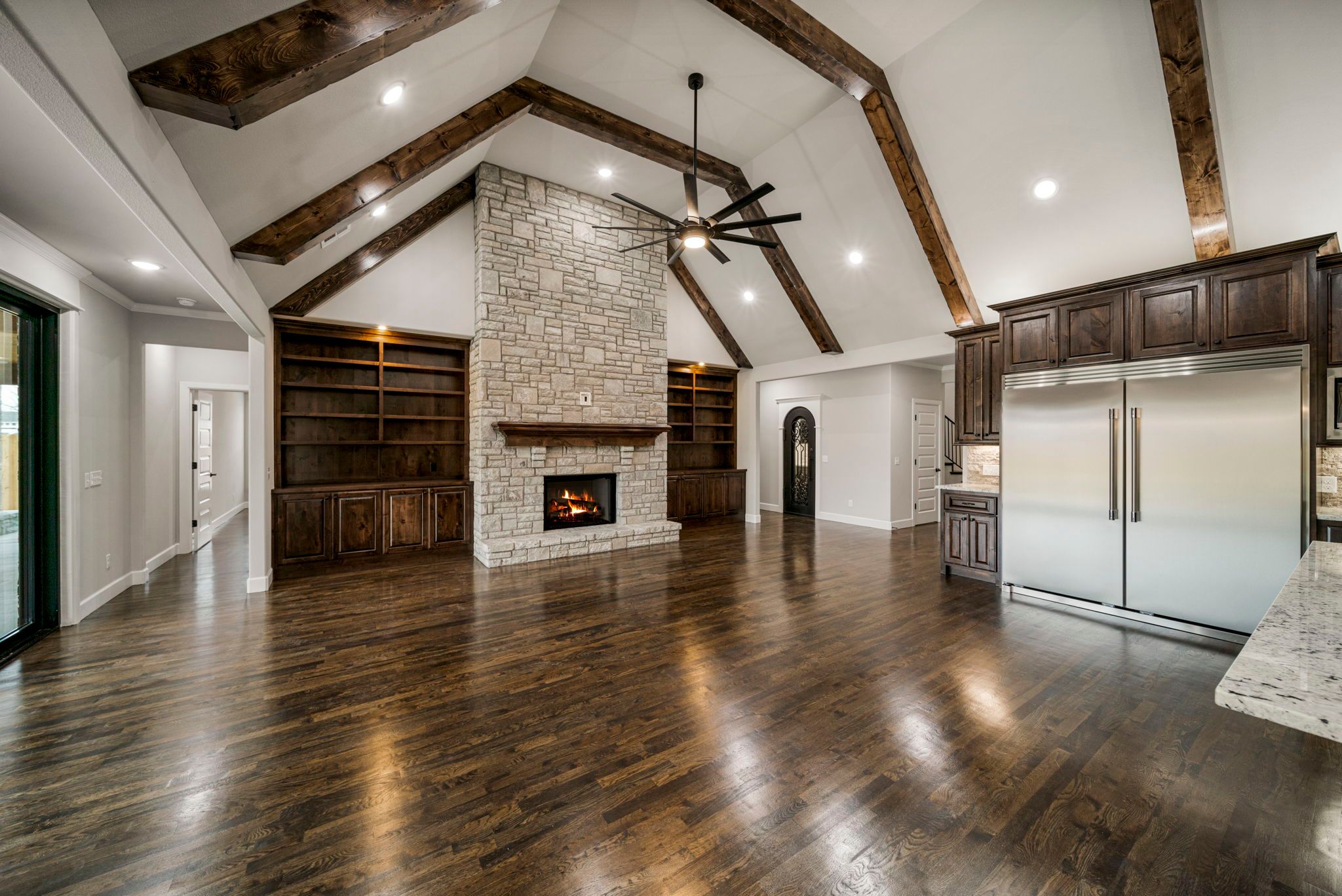 Warm and welcoming living room with designer finishes and a spacious layout by Mahogany Homes Tulsa.