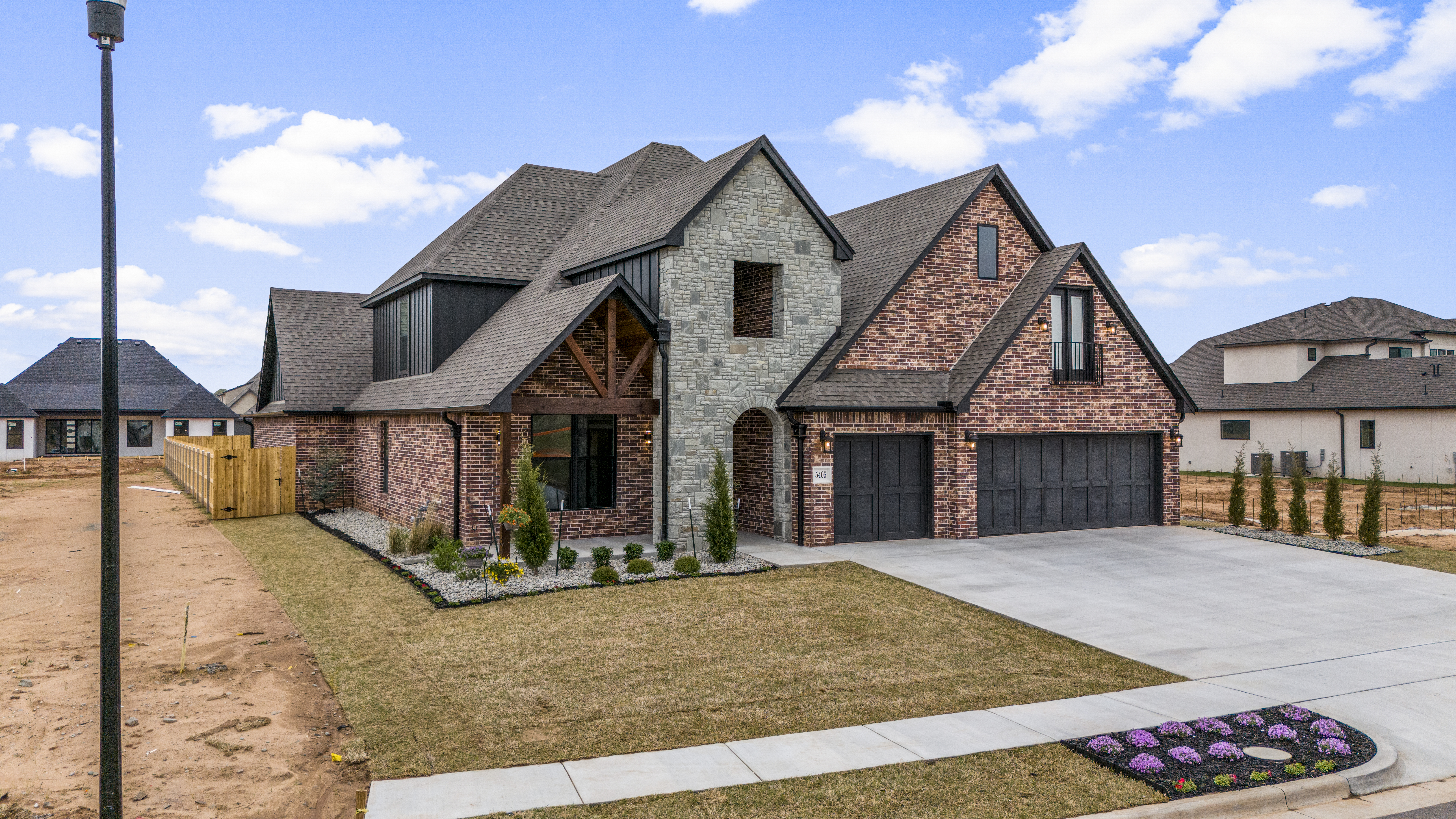 Contemporary, eco-friendly home exterior with innovative features by Mahogany Homes Tulsa.