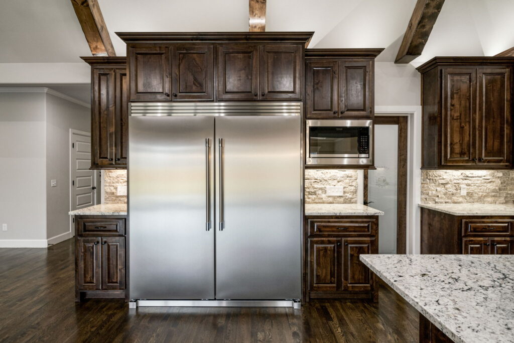 High-end kitchen with designer finishes and an open layout by Mahogany Homes.