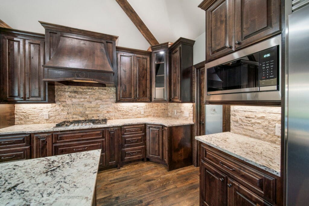 Sophisticated kitchen with modern cabinetry and top-quality appliances by Mahogany Homes.