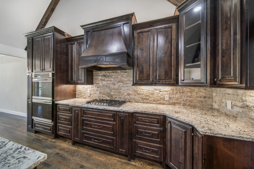 Modern kitchen with ample storage and high-end finishes by Mahogany Homes.