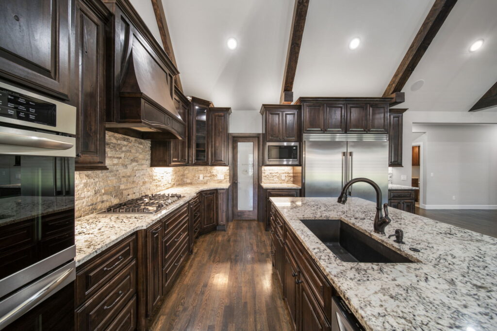 Beautifully designed kitchen with a large island and contemporary finishes by Mahogany Homes.