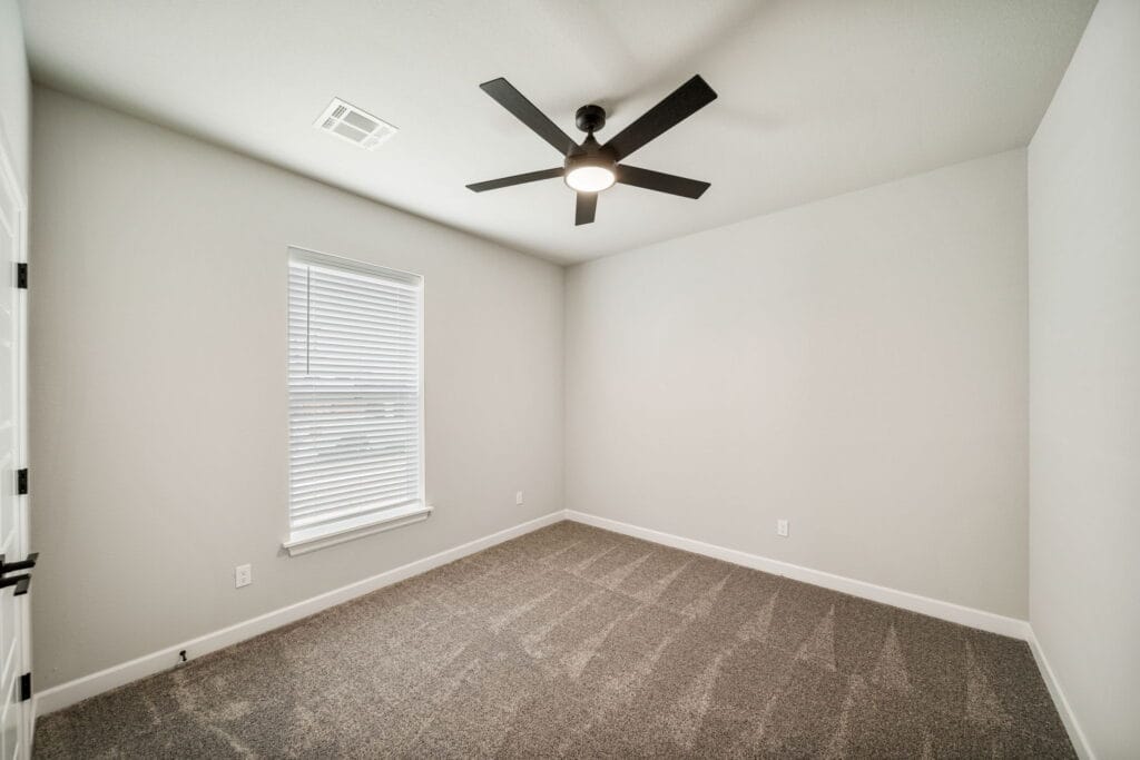 Bright and modern floor plan with oversized windows, an open living room, and a designer kitchen by Mahogany Homes.