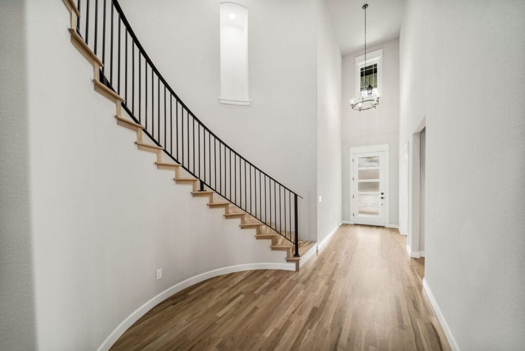 Sophisticated floor plan with a grand entrance, open kitchen, and spacious living areas by Mahogany Homes Tulsa