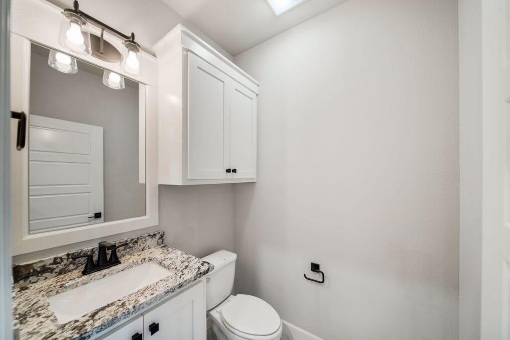 Elegant bathroom with a modern shower design and custom tile work by Mahogany Homes.