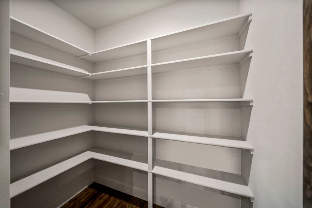 Luxury kitchen featuring stainless steel appliances and beautiful countertops by Mahogany Homes.