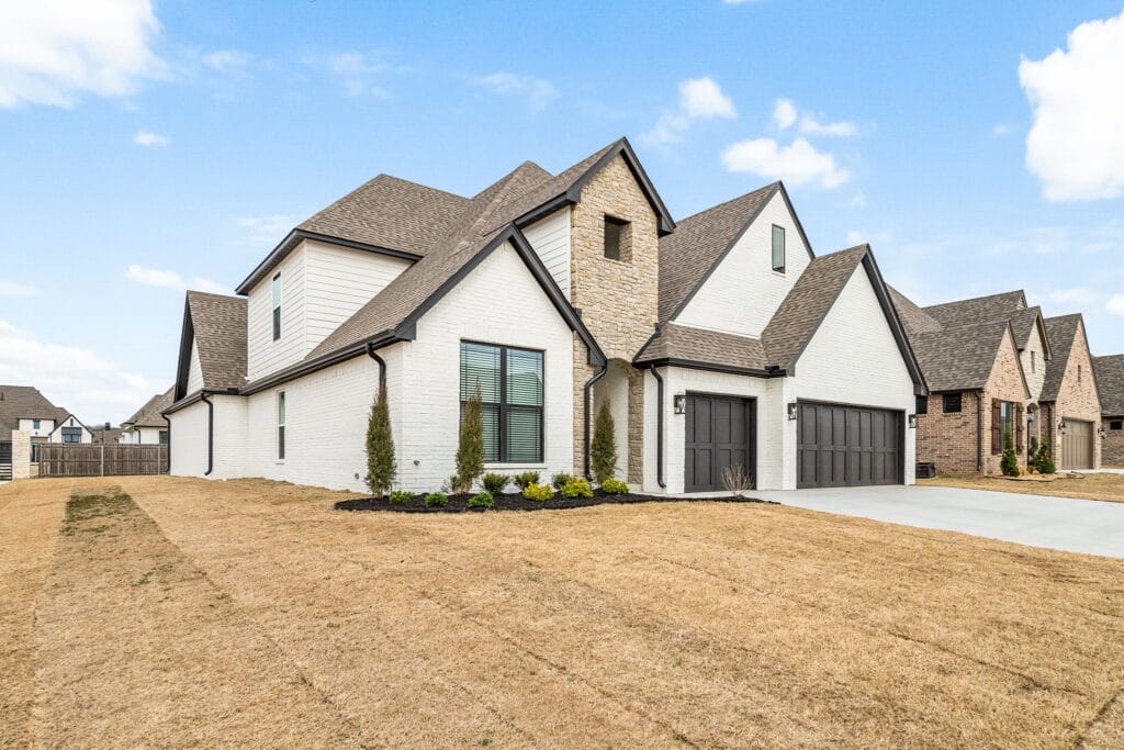 Custom home exterior with bold design elements and modern finishes by Mahogany Homes.