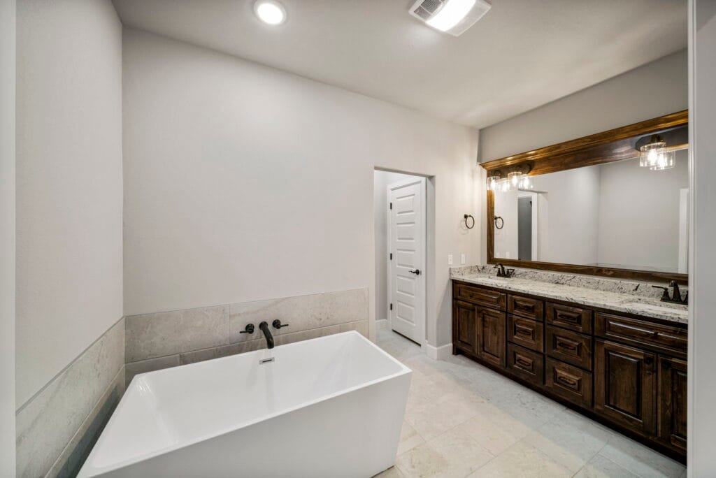 Well-designed bathroom with stylish fixtures, a walk-in shower, and ample storage by Mahogany Homes Tulsa