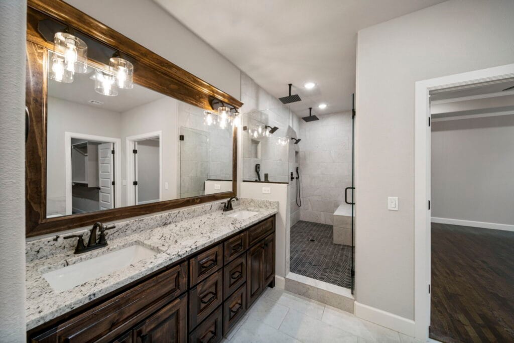 Refined bathroom featuring high-end materials, including a freestanding tub and modern vanity by Mahogany Homes.