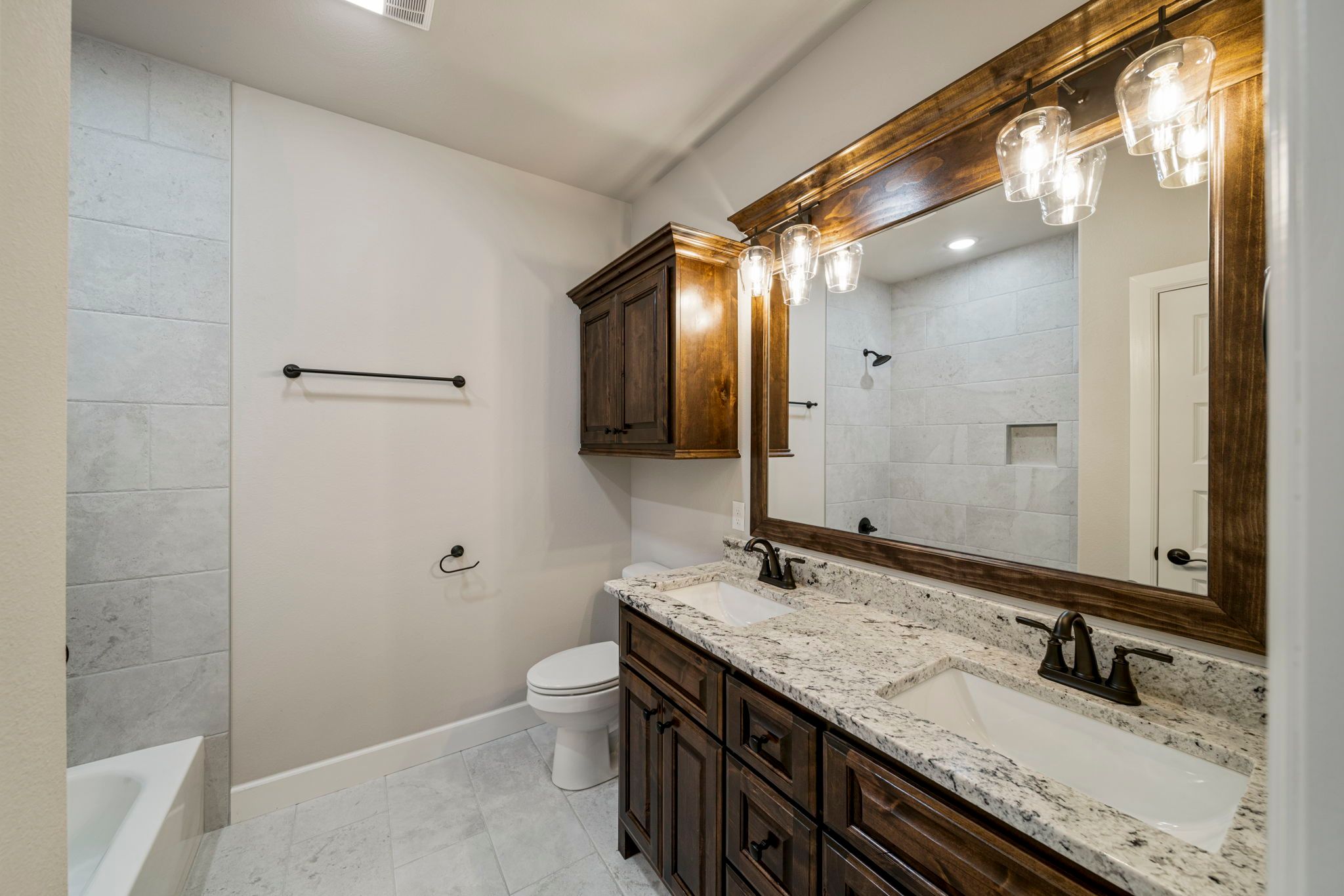 Bright and spacious bathroom with a luxurious freestanding tub and custom finishes by Mahogany Homes.