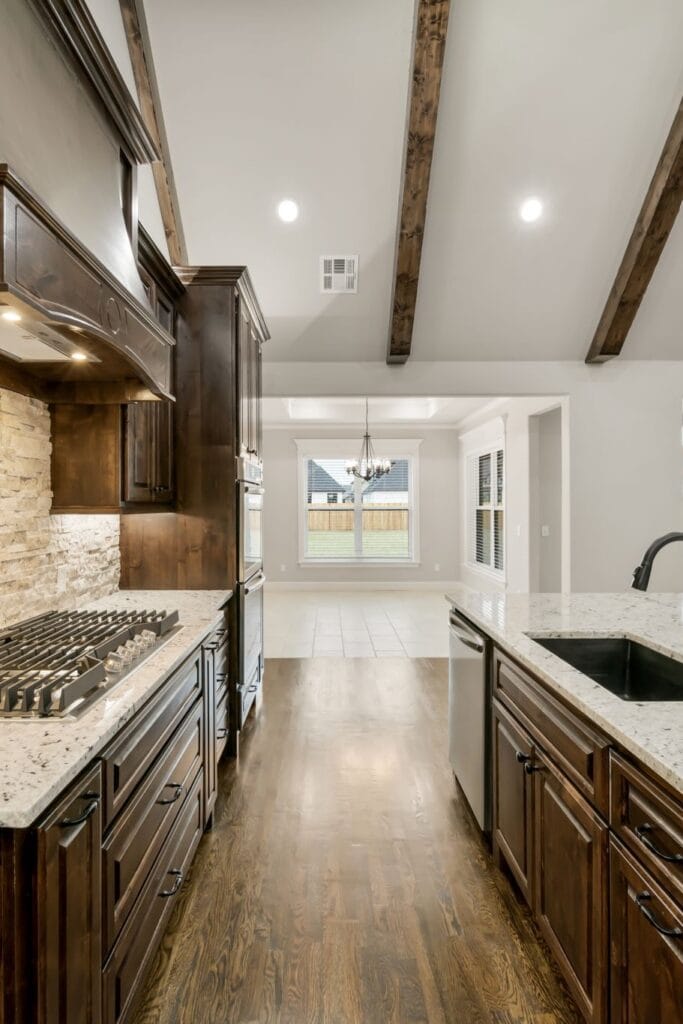 Stylish kitchen with sleek cabinetry and premium fixtures by Mahogany Homes Tulsa.