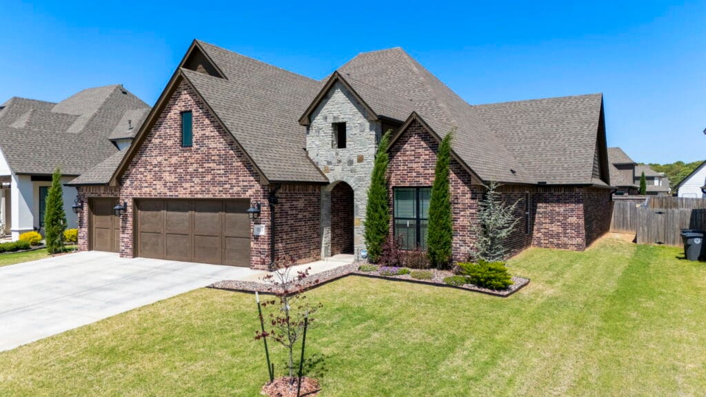 Sophisticated custom home exterior with eco-friendly materials by Mahogany Homes.