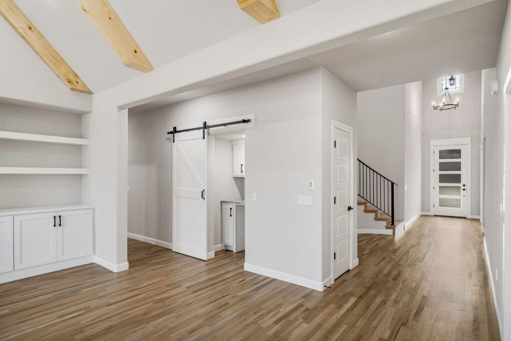 Spacious living room with elegant furniture and a sleek, modern aesthetic by Mahogany Homes Tulsa.