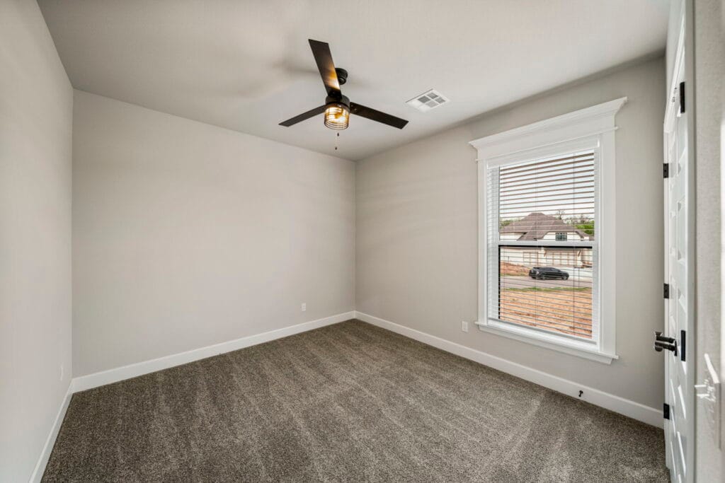 Open-concept floor plan with expansive living spaces and stylish finishes by Mahogany Homes Tulsa