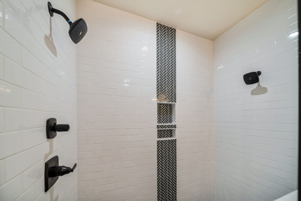 Modern bathroom featuring a spacious walk-in shower and elegant fixtures by Mahogany Homes.