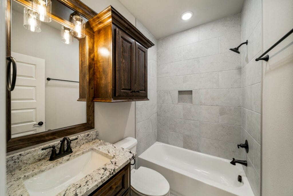 Luxury bathroom with custom details, including a large tub, dual sinks, and elegant finishes by Mahogany Homes.