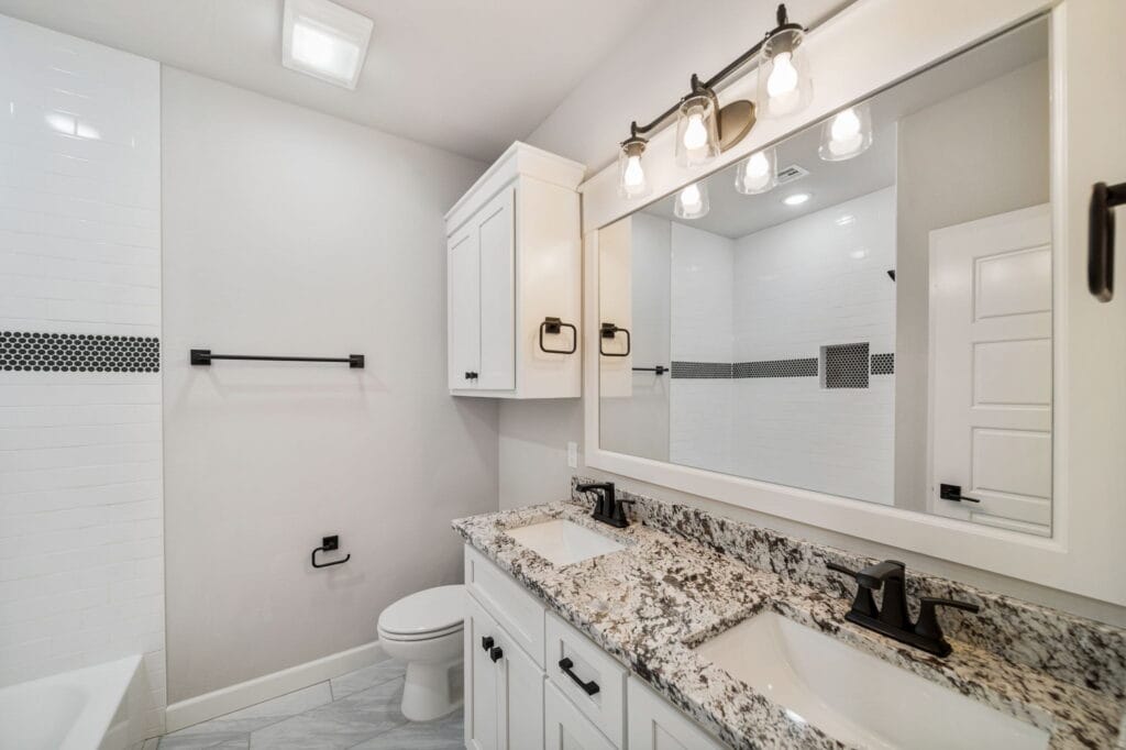 Contemporary bathroom with custom cabinetry, a glass shower, and stylish decor by Mahogany Homes