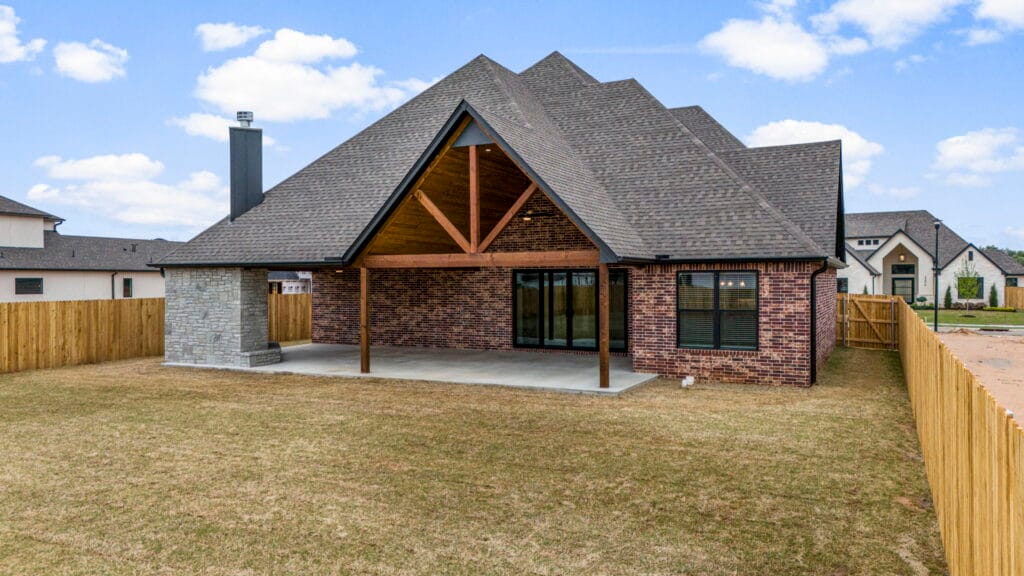 Luxurious custom home exterior with large windows and a stylish design by Mahogany Homes.