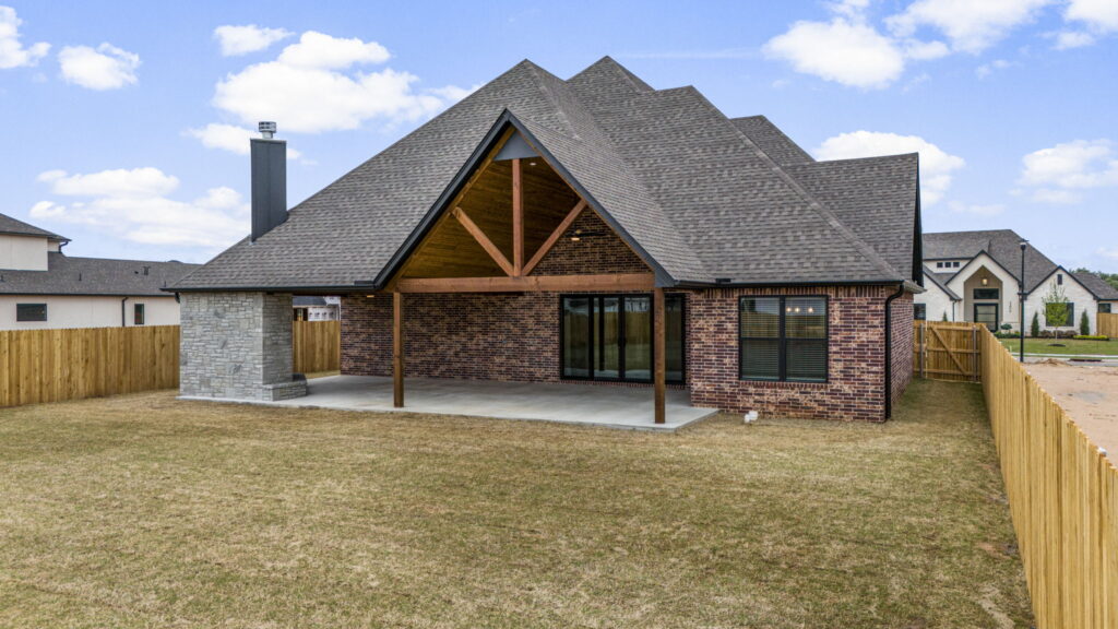 Modern home exterior with expansive windows and a welcoming entryway by Mahogany Homes.