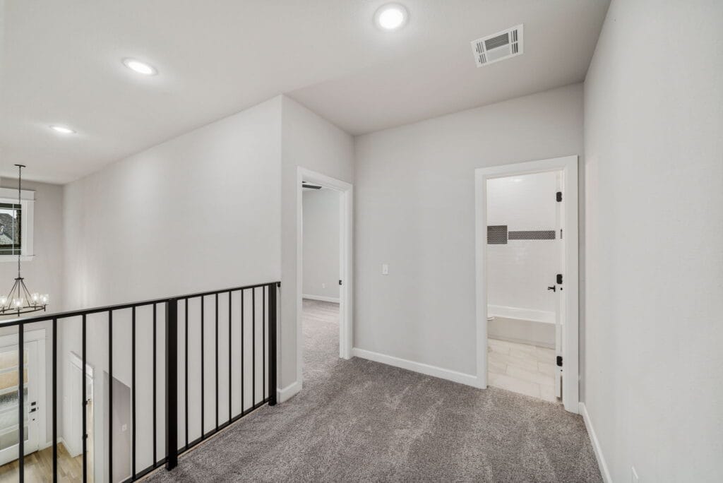 Bright floor plan with an expansive living area and modern kitchen design by Mahogany Homes Tulsa.