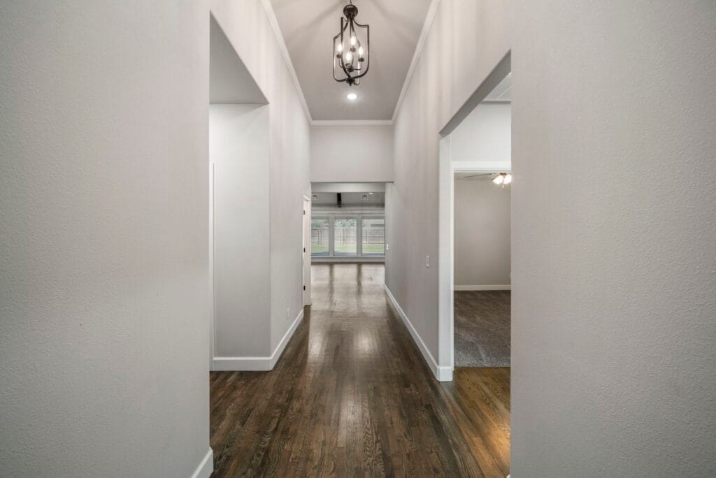 Modern floor plan with a large open living room and gourmet kitchen by Mahogany Homes Tulsa.