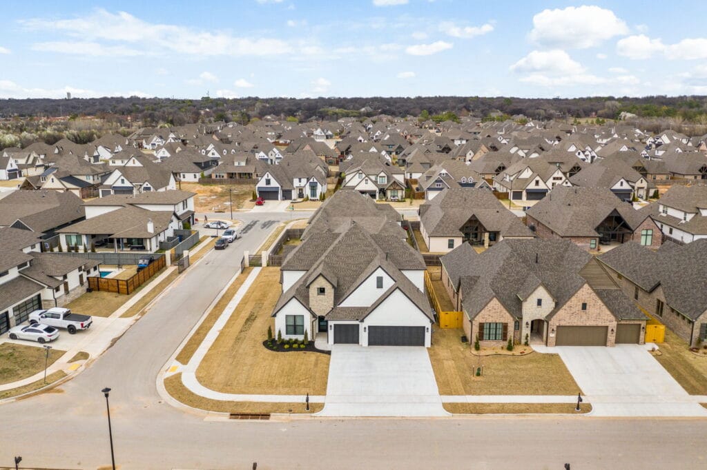 Inviting exterior of a custom-built home with sleek lines and a minimalist design by Mahogany Homes Tulsa.